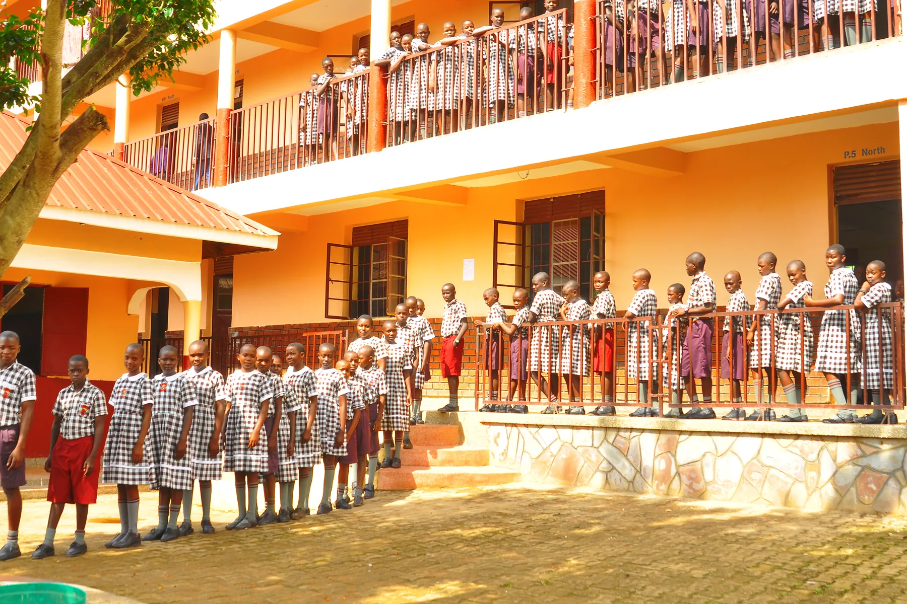 Pupils on the balconies and steps of the classroom block